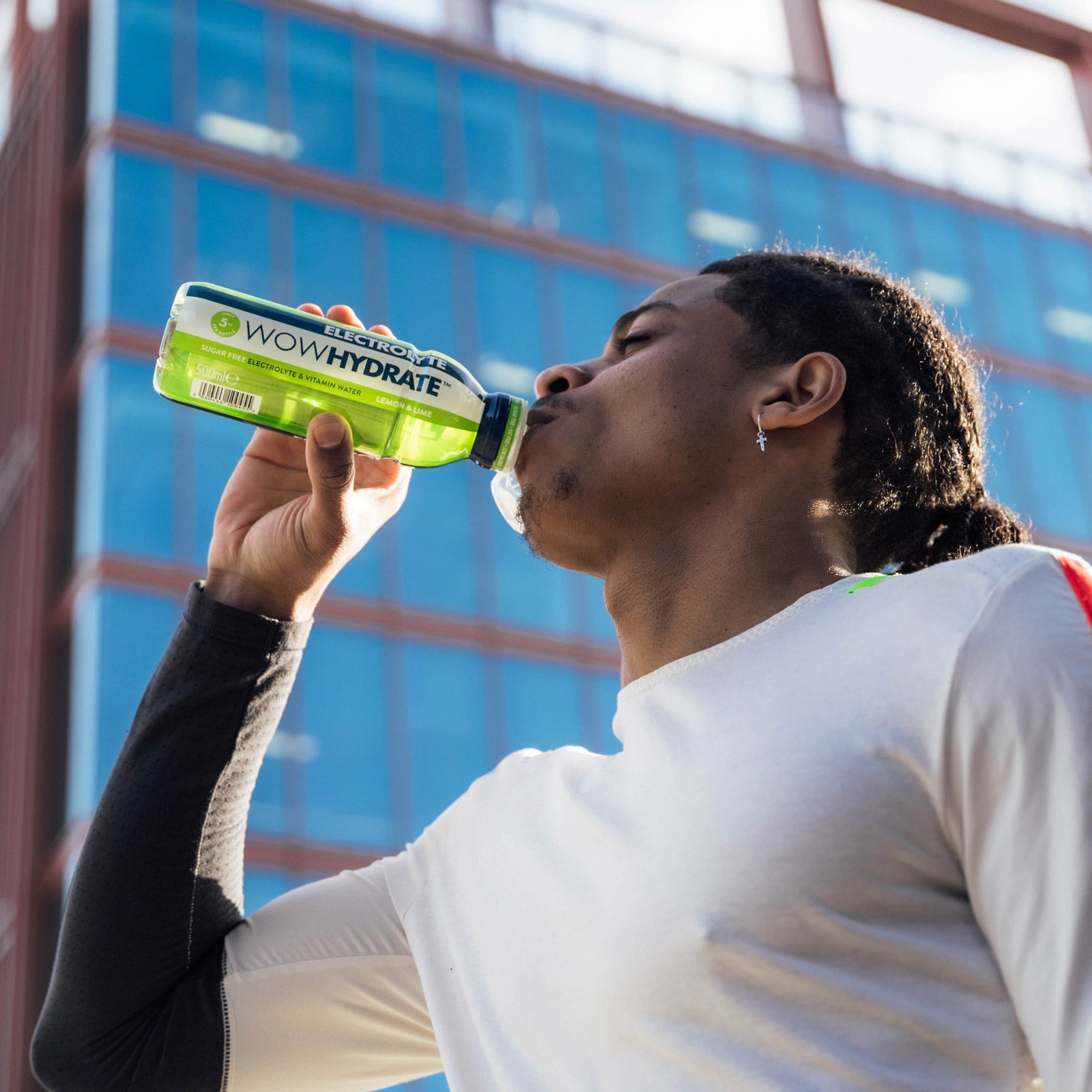 wowhydrate electrolyte being drunk by a man in running attire